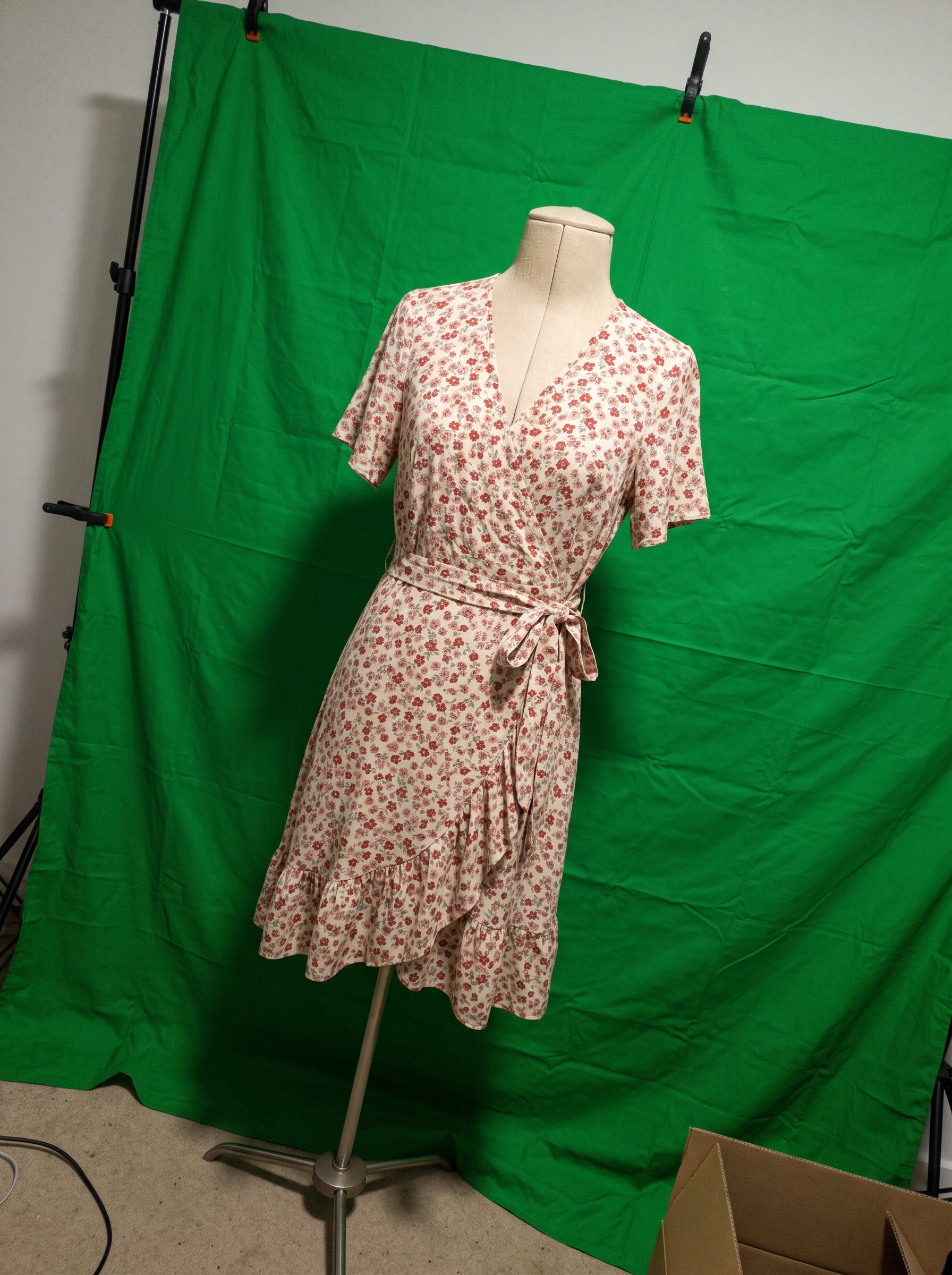 The floral wrap dress on a mannequin, shot on a phone
